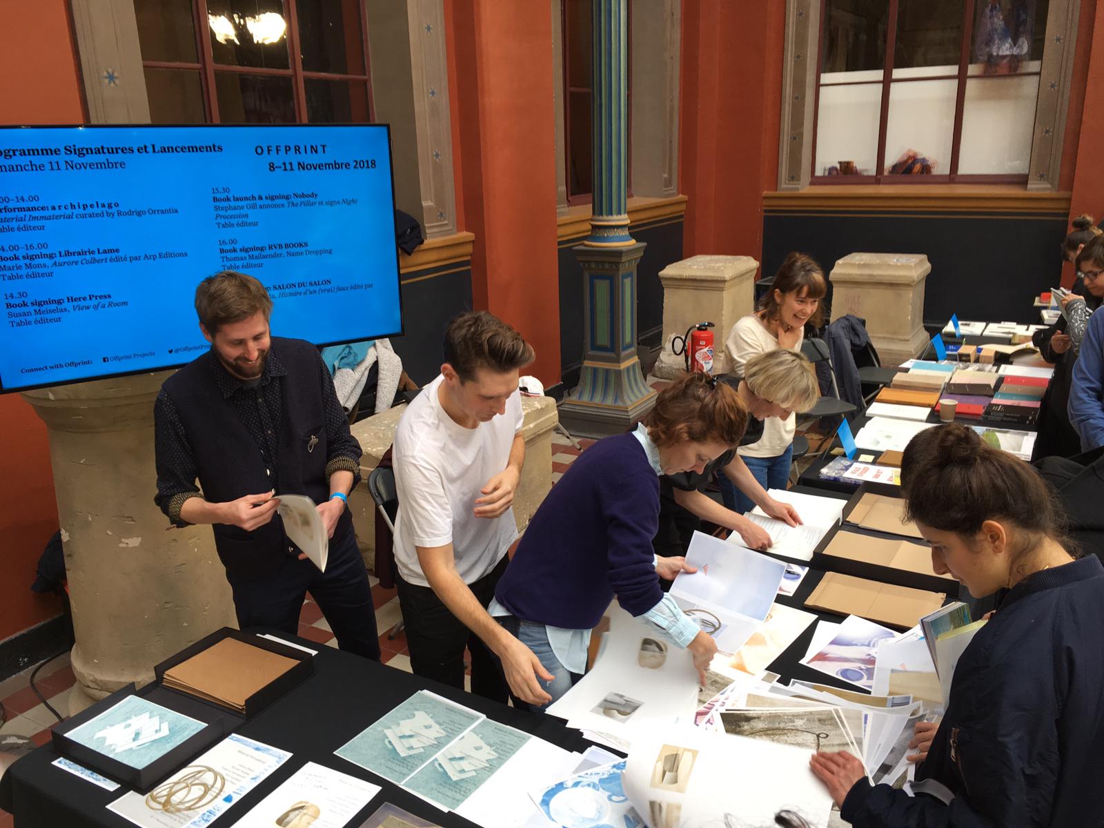 live performance of artists at Offprint Paris assembling a zine